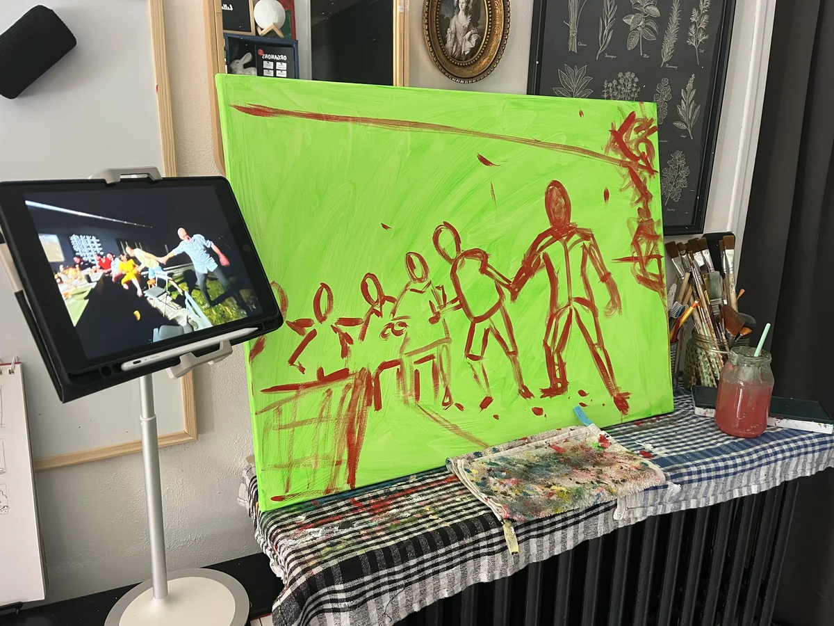 An unfinished neon-green painting with loose red figures dancing in a line, beside a tablet showing the nighttime reference photo.